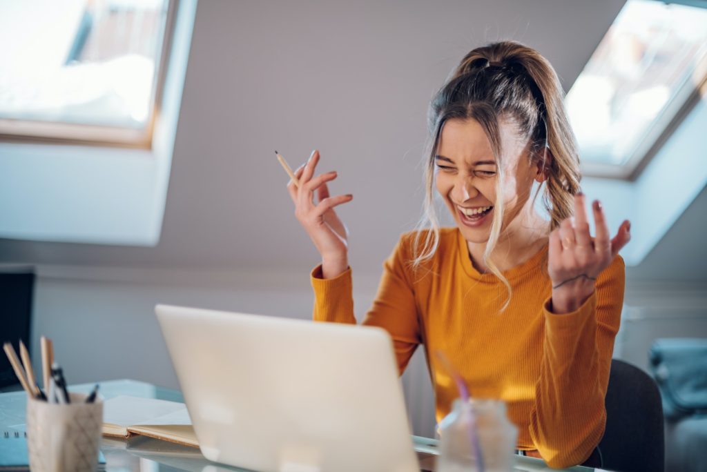 Woman having web call on a laptop while working at home