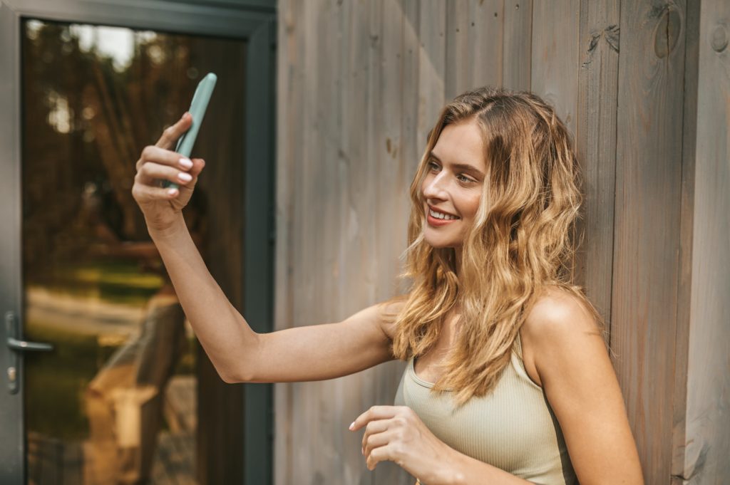 Beautiful woman taking selfie on smartphone